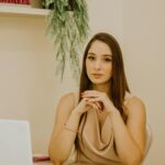 Elegant businesswoman sitting at desk in a modern office in São Paulo.